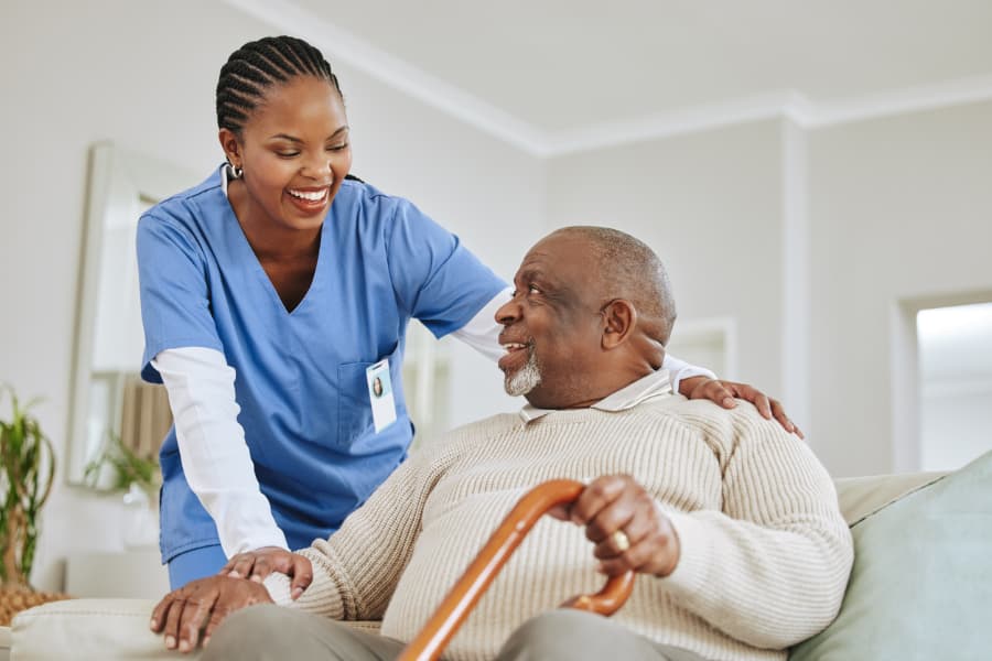 Caregiver-assisting-a-patient-get-up-from-seated-position (1)